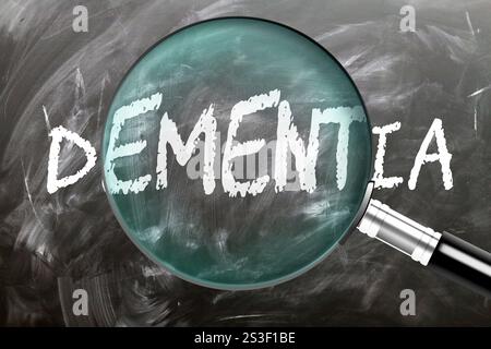 Dementia - learn, study and inspect it. Taking a closer look at dementia. A magnifying glass enlarging word 'dementia' written on a blackboard Stock Photo