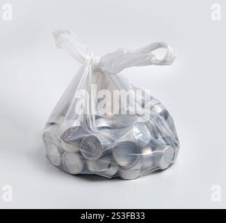 Empty aluminum cups from burnt tea lights candles in a tied plastic bag. Stock Photo