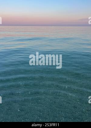 crystal clear water and a beautiful sunrise on Indian Rocks beach in Florida Stock Photo