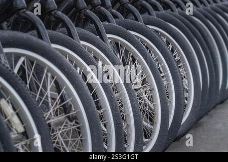Closeup of Row of Bicycle Tires on a Rainy day Stock Photo