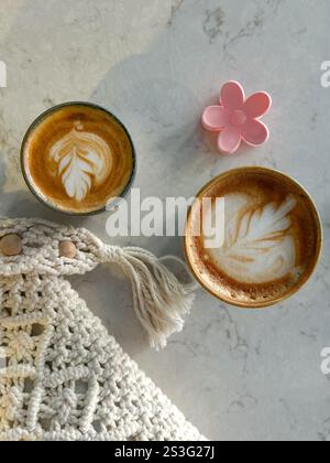 This photo captures a peaceful moment on a spring day in Istanbul. The image features two beautifully crafted lattes with intricate foam art, placed o Stock Photo