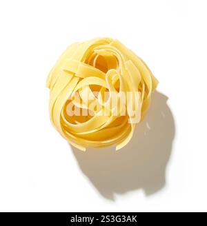 raw italian pasta tagliatelle isolated on white background, top view Stock Photo