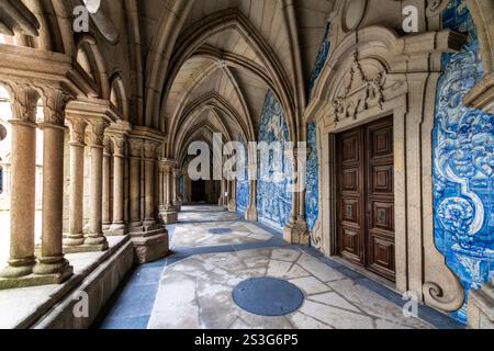View from an arched hallway with vaulted ceilings and Portuguese blue artist tiles at the medieval cloister at the Porto Cathedral, in Porto Portugal Stock Photo