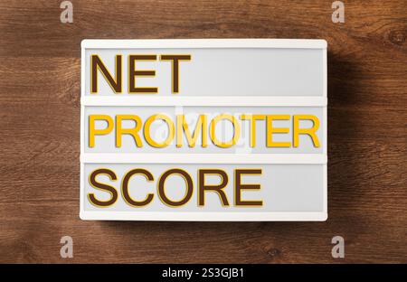 Letter board with text Net Promoter Score (NPS) on wooden table, top view. Customer satisfaction assessment Stock Photo