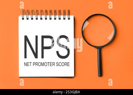 NPS concept on magnifying glass on white background with blue folder ...