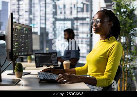 Machine learning infrastructure engineer designing and developing algorithms that enable machines to learn from data. Woman in office training and deploying large scale deep learning models Stock Photo