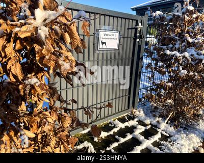 A German danger dog sign on the fence at a privat house in winter  Stock Photo