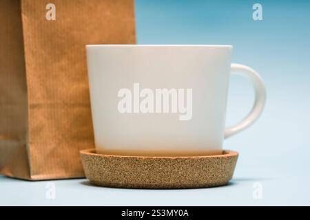 White porcelain tea or coffee cup on blue background Stock Photo