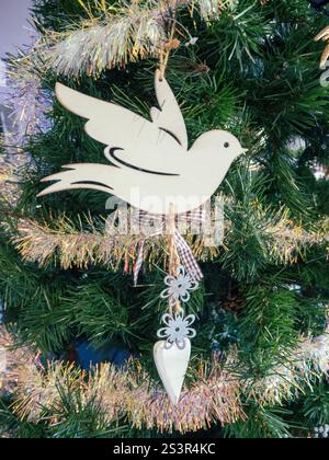 Peace dove Christmas decoration and gold tinsel on the Xmas tree Stock Photo