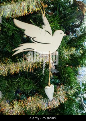 Peace dove Christmas decoration and gold tinsel on the Xmas tree Stock Photo