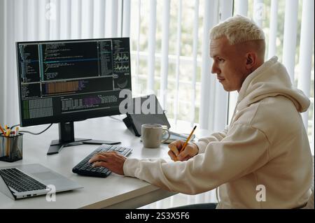 Programmer Working With Metadata On Computer Stock Photo
