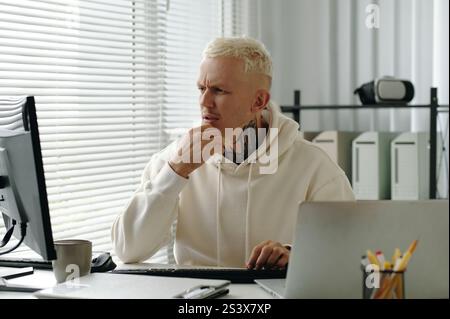 IT Developer Working In Office Stock Photo
