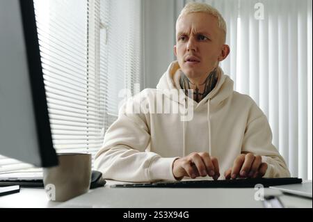Programmer Typing On Computer In Office Stock Photo