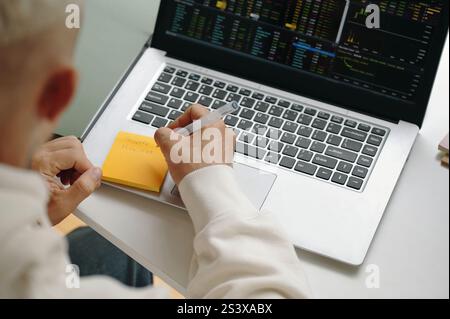Programmer Writing Password On Note Stock Photo