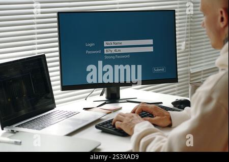 Programmer Entering Password On Computer Stock Photo