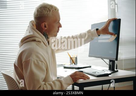 User Sticking Note With Password On Computer Stock Photo