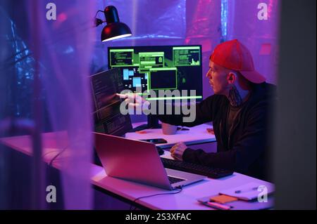 IT Worker Working On Computer With Metadata Stock Photo