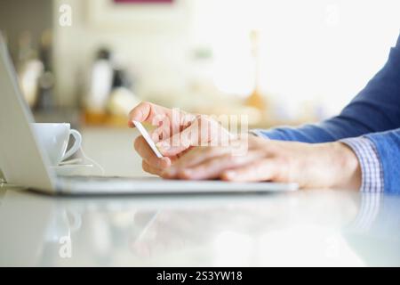 Close up of Man's Hands Holding Credit Card and Using Laptop Stock Photo