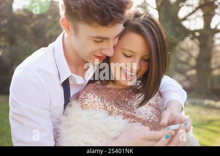 Young Couple Using Cell Phone Stock Photo