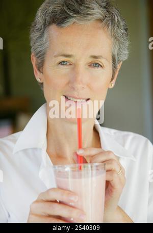 Woman Drinking Smoothie with Straw Stock Photo