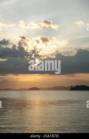 Sunset over ocean with dramatic clouds and distant islands in Thailand Stock Photo