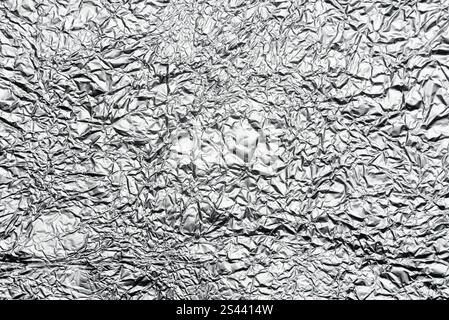 crumpled aluminum foil background or overlay Stock Photo