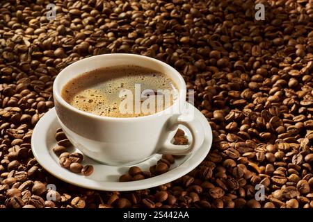 Cup of coffee on a background of roasted beans. Selective focus Stock Photo