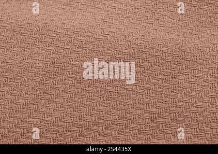 Close-up of intricately woven textured fabric in earthy brown shade. Stock Photo