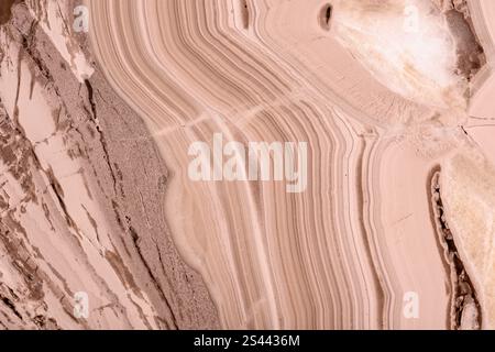 Mocha-mousse opal texture showcasing detailed, wavy patterns and earthy elegance. Stock Photo