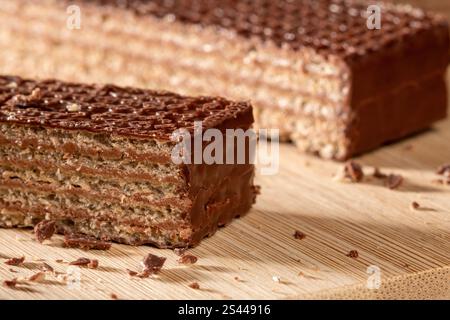 Wafer chocolate cake cut into pieces on kitchen table extreme close up top view Stock Photo