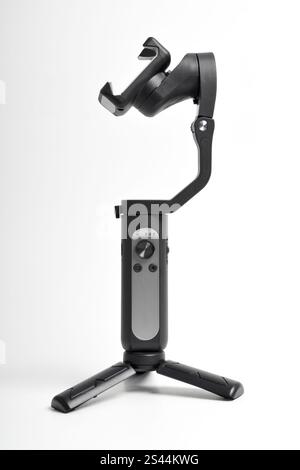 Gimbal stabilizer for Smartphone isolated on white background. Modern stabilizer-gimbal for photo-video shooting. Gadgets for blogging, streaming, vid Stock Photo