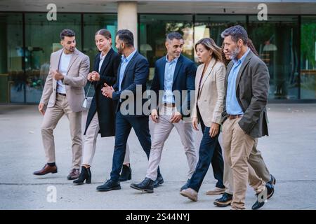 Group of Business Professionals Walking and Talking Outdoors Stock Photo