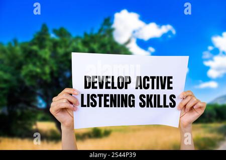 Develop active listening skills message written on ripped torn yellow ...