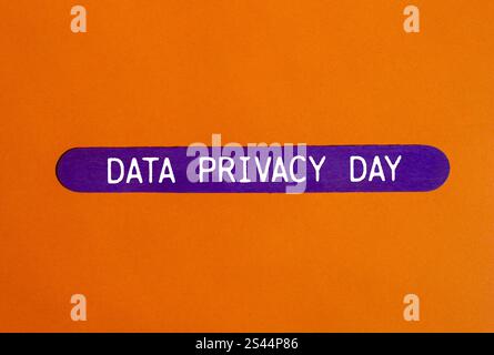 Data privacy day message written on purple wooden stick with orange background. Conceptual data privacy day symbol. Copy space. Stock Photo