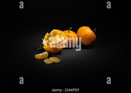 Fresh peeled orange fruit on an isolated black background, perfect for the background of your design ideas Stock Photo