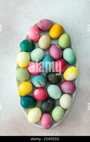 Multi-colored Easter eggs in an oval dish , top view, Happy Easter holiday Stock Photo