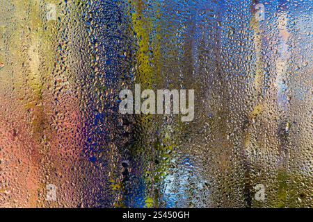 colored background of water droplets. condensation on the glass Stock Photo