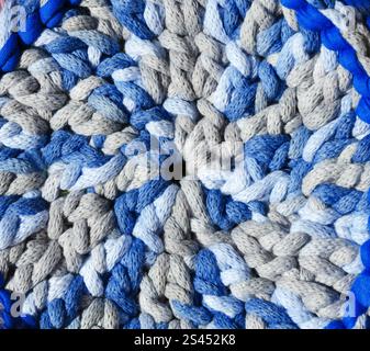 Cotton yarn. Cotton cord pattern in blue and light blue. A fragment of a women's handbag made from ECO yarn. Stock Photo