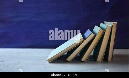 Row of blue books on blue background, reading, learning, education or home office concept,free copy space. Stock Photo