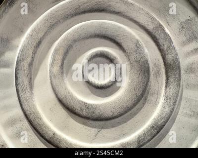 Close up of porcelain tiles with circle spiral pattern. Grey and white painted porcelain tiles in round and circle shape. Seamless background texture. Stock Photo