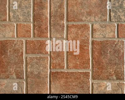 Close up of natural red tiles with random rectangular and square pattern. Geometric random size rectangular red colored porcelain tiles made of clay Stock Photo