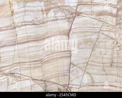 Close up of beige yellow natural marble slab texture. Light yellow cream marble with dark brown veins and random cut, seamless wall panel background Stock Photo