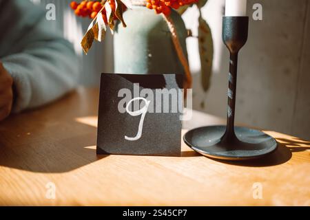 white number nine sign of a black stand for ordering food placing on a wood table in a cafe Stock Photo