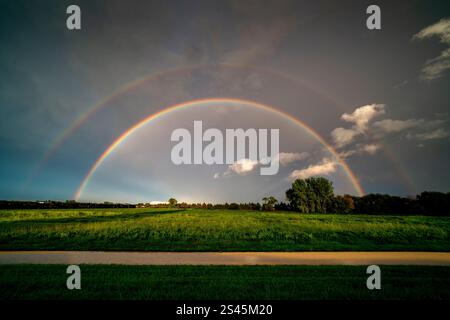 A rainbow against a dark sky south of Winkler, Manitoba, Canada. Stock Photo