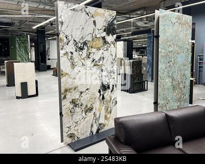 Kyiv, Ukraine - January 10, 2025: Exquisite marble slabs in diverse designs are showcased in a contemporary showroom setting, highlighting their natur Stock Photo