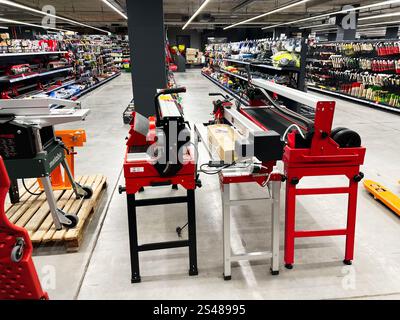 Kyiv, Ukraine - January 10, 2025: A well-organized hardware store with various tools and industrial equipment displayed for sale, including machinery Stock Photo