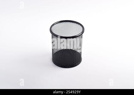Box of colored pencils isolated on white background. Empty black basket Pen holder. Close up Stock Photo
