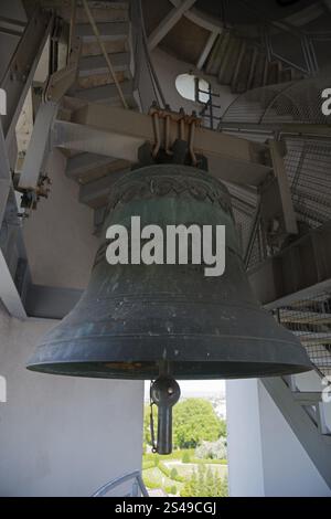 Large metal bell inside a tower with a spiral staircase and a view of the landscape, bell tower of the Basilica of the Nativity of the Virgin Mary, Ch Stock Photo