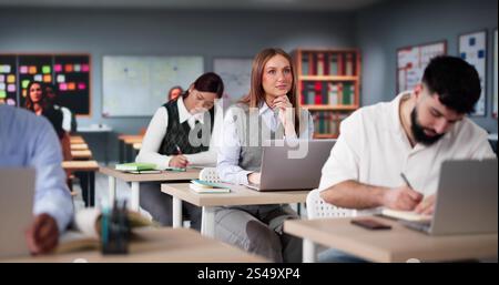 Diverse College Students Group In Classroom With Laptop Computers Stock Photo