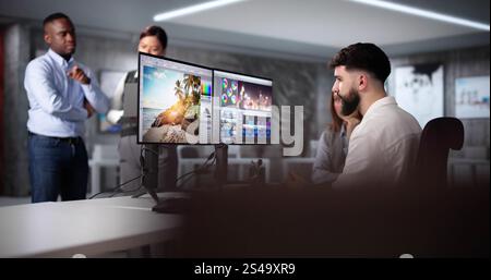 Graphic Designer Artist Team Working On Multiple Computer Screens Stock Photo